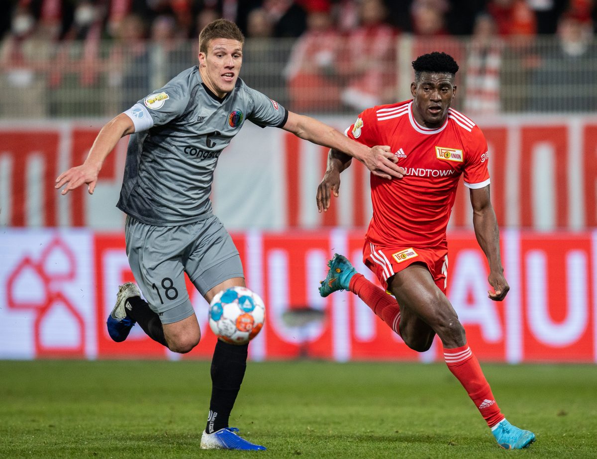 Taiwo Awoniyi of 1.FC Union Berlin is challenged by Jakov Medic of FC St. Pauli during the DFB Cup quarter final match between 1. FC Union Berlin and FC St. Pauli at Stadion An der Alten Foersterei on March 01, 2022 in Berlin, Germany.