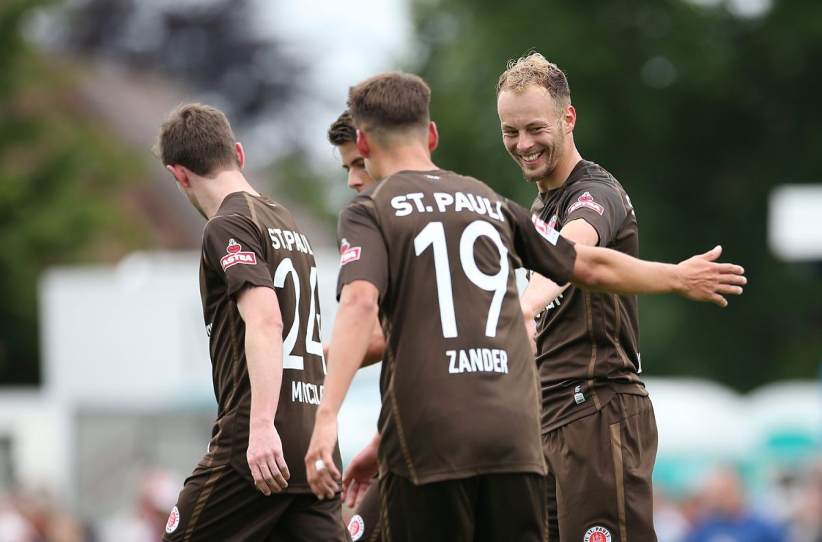 HASELDORF, GERMANY - JUNE 19: Carlo Boukhalfa (R) of FC St. Pauli celebrate after scoring during the preseason friendly match between Hetlinger MTV and FC St. Pauli at Deichstadion on June 19, 2022 in Haseldorf, Germany.