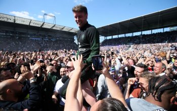 HAMBURG, GERMANY - MAY 12: Fabian Huerzeler, Head Coach of FC St. Pauli, celebrates victory and promotion to the Bundesliga with the fans following the Second Bundesliga match between FC St. Pauli and VfL Osnabrück at Millerntor Stadium on May 12, 2024 in Hamburg, Germany. (Photo by Selim Sudheimer/Getty Images)