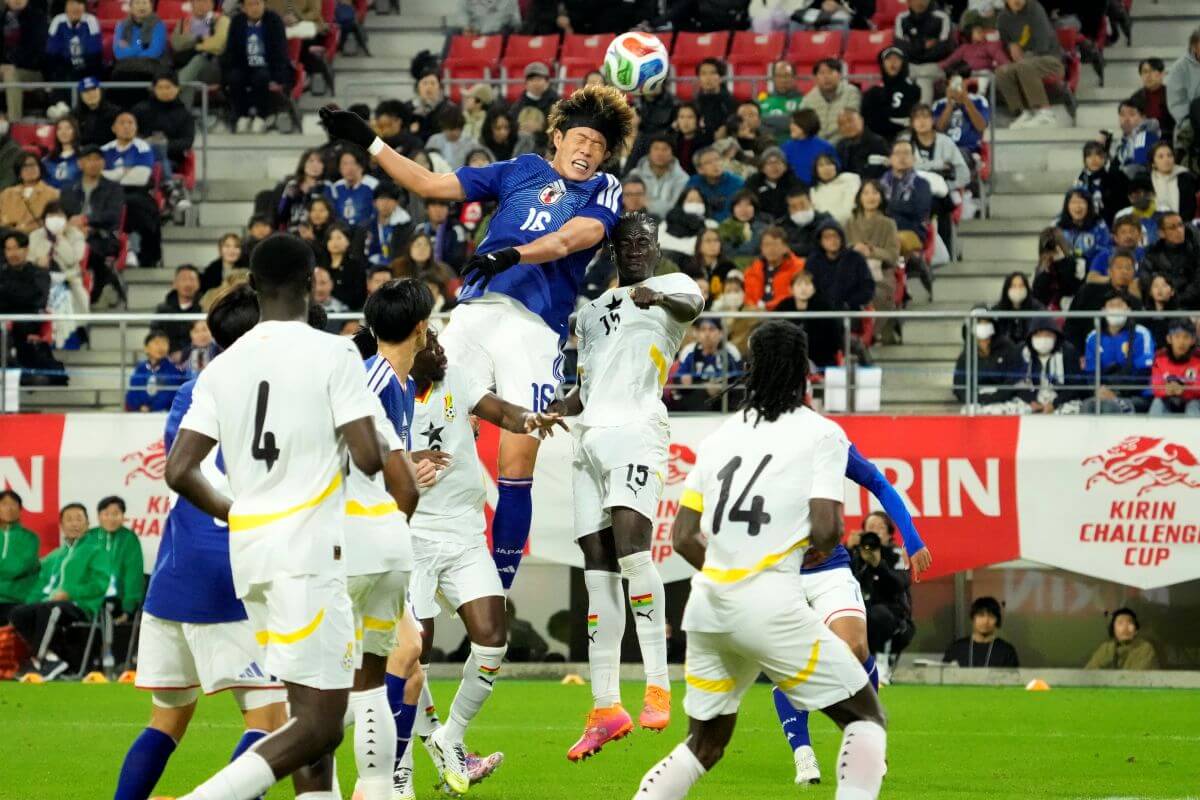 TOYOTA, JAPAN - NOVEMBER 14: Tomoya Ando of Japan and Kojo Peprah Oppong of Ghana compete for the ball during the international friendly match between Japan and Ghana at Toyota Stadium on November 14, 2025 in Toyota, Aichi, Japan. (Photo by Toru Hanai/Getty Images)