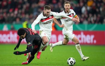 LEVERKUSEN, GERMANY - FEBRUARY 03: Malik Tillman of Bayer 04 Leverkusen clashes with James Sands of FC St. Pauli during the DFB Cup Quarter Final match between Bayer 04 Leverkusen and FC St. Pauli at BayArena on February 03, 2026 in Leverkusen, Germany. (Photo by Pau Barrena/Getty Images)