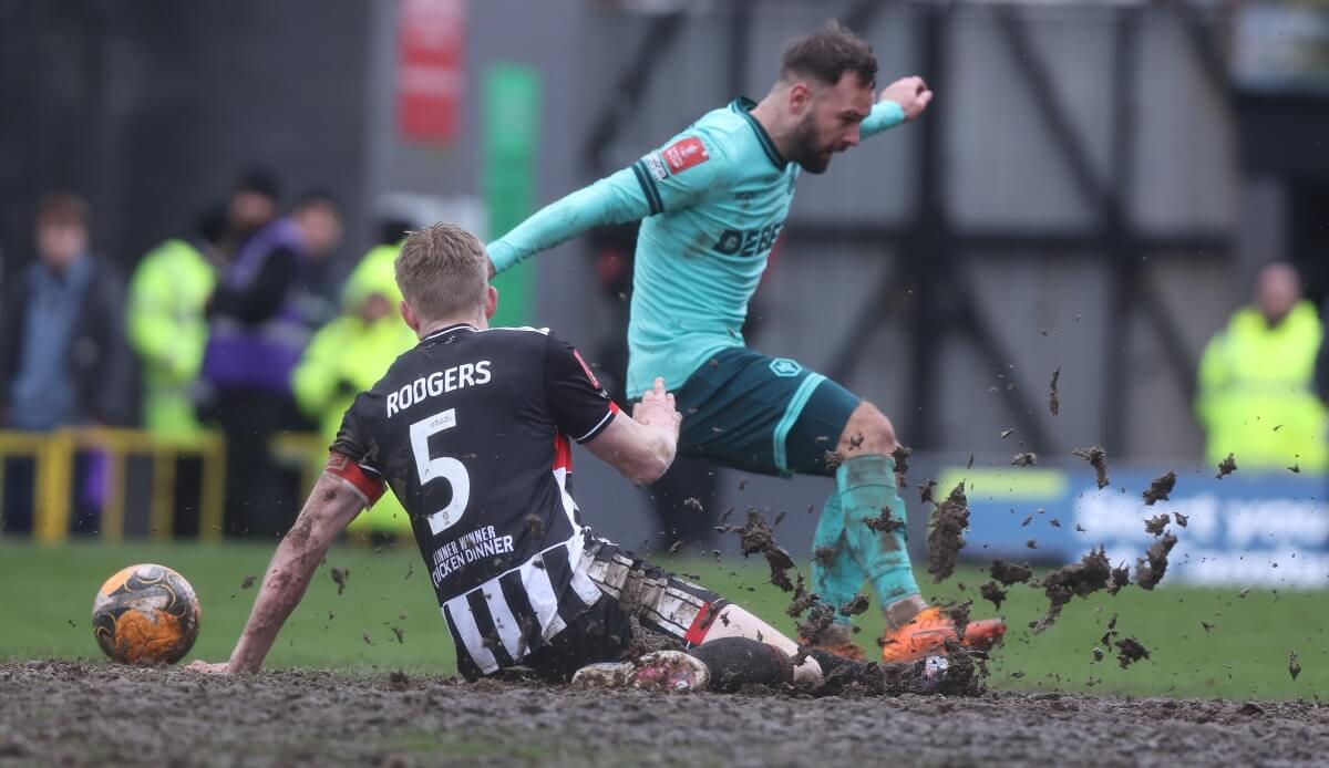 Adam Armstrong of Wolverhampton Wanderers and Harvey Rodgers of Grimsby Town battle for possession during the Emirates FA Cup Fourth Round match between Grimsby Town and Wolverhampton Wanderers on February 15, 2026 in Grimsby, England. (Photo by Nigel Roddis/Getty Images)