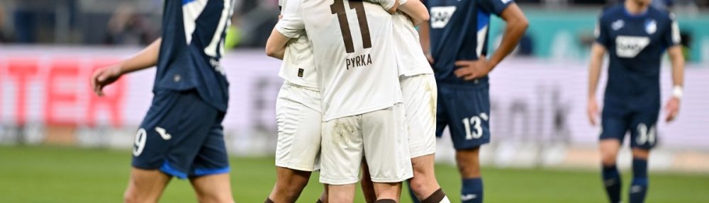 SINSHEIM, GERMANY - FEBRUARY 28: Joel Chima Fujita, Jackson Irvine and Arkadiusz Pyrka all of FC St. Pauli celebrate at the final whistle during the Bundesliga match between TSG Hoffenheim and FC St. Pauli at PreZero-Arena on February 28, 2026 in Sinsheim, Germany. (Photo by Sebastian Widmann/Getty Images)