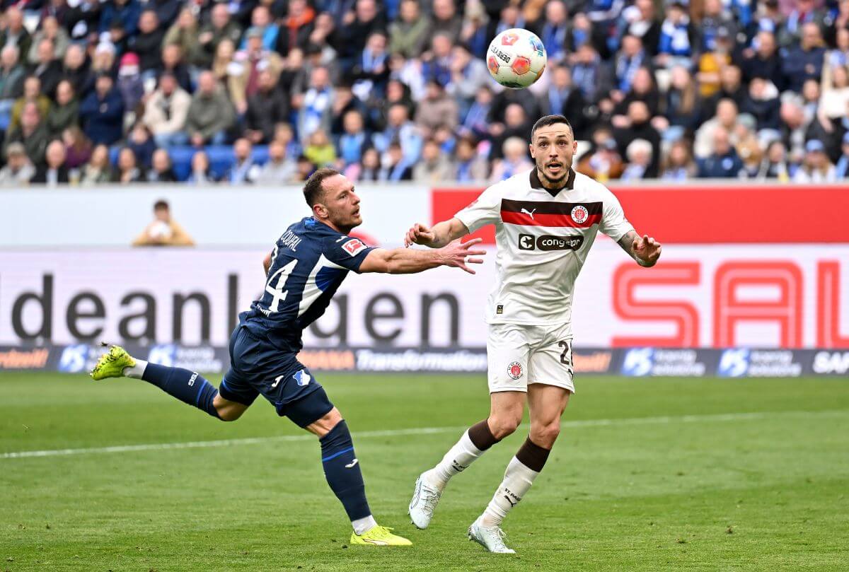 SINSHEIM, GERMANY - FEBRUARY 28: Mathias Pereira Lage of FC St. Pauli scores his team's first goal under pressure from Vladimir Coufal of TSG 1899 Hoffenheim during the Bundesliga match between TSG Hoffenheim and FC St. Pauli at PreZero-Arena on February 28, 2026 in Sinsheim, Germany. (Photo by Sebastian Widmann/Getty Images)
