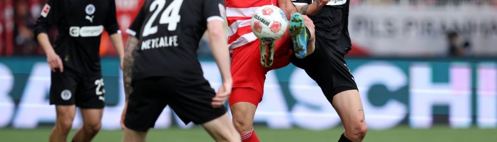 BERLIN, GERMANY - APRIL 05: Rani Khedira of 1. FC Union Berlin clashes with Jackson Irvine of FC St. Pauli during the Bundesliga match between 1. FC Union Berlin and FC St. Pauli at Stadion An der Alten Foersterei on April 05, 2026 in Berlin, Germany. (Photo by Ronny Hartmann/Getty Images)
