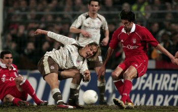 HAMBURG, GERMANY - APRIL 12: Felix Luz (L) of St.Pauli shoots at goal during the DFB German Cup Semi Final match between FC St. Pauli and Bayern Munich at the Millerntor Stadium on April 12, 2006 in Hamburg, Germany. (Photo by Martin Rose/Bongarts/Getty Images)