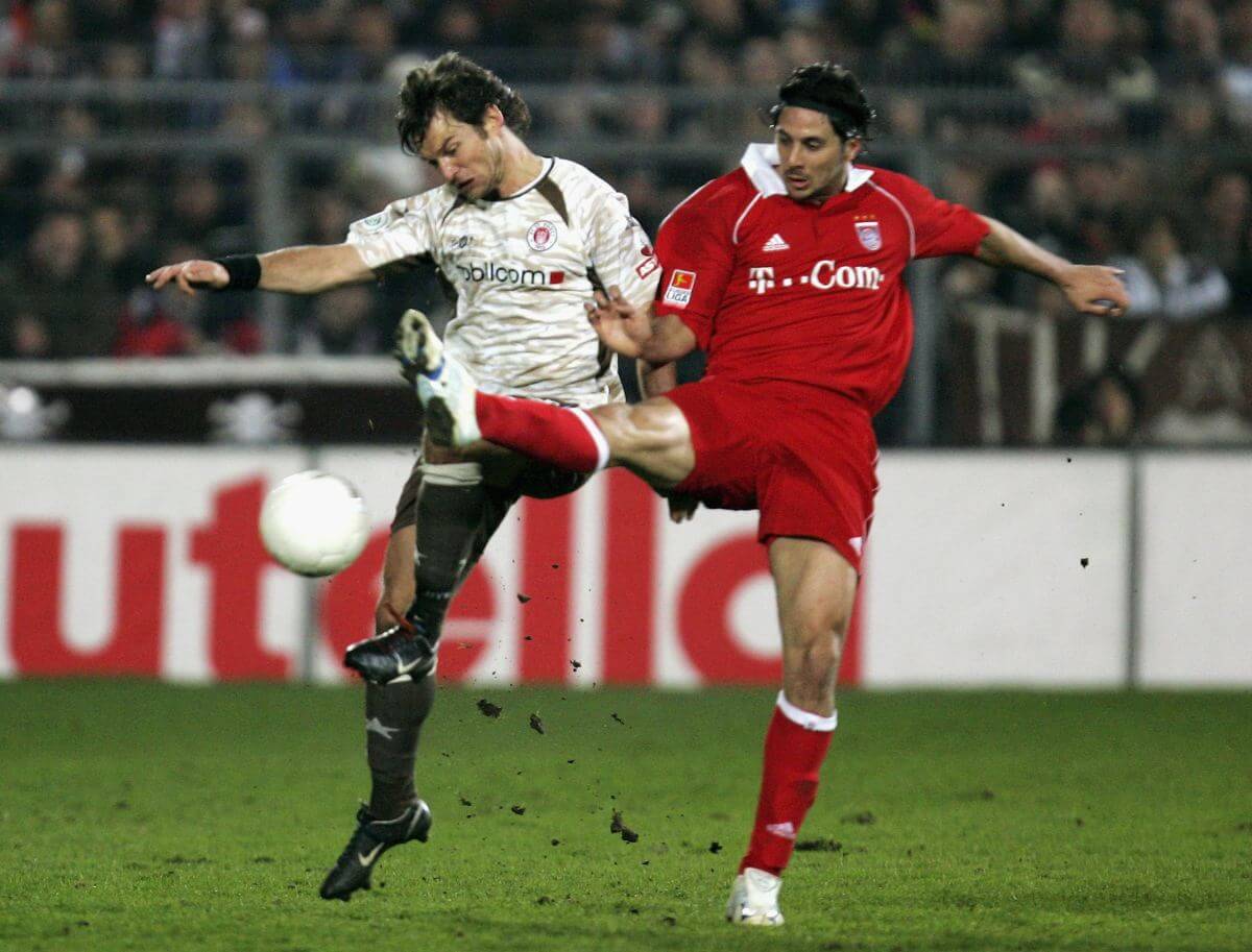 HAMBURG, GERMANY - APRIL 12: Florian Lechner (L) of St.Pauli challenges for the ball with Claudio Pizarro (R) of Munich during the DFB German Cup Semi Final match between FC St. Pauli and Bayern Munich at the Millerntor Stadium on April 12, 2006 in Hamburg, Germany. (Photo by Alexander Hassenstein/Bongarts/Getty Images)