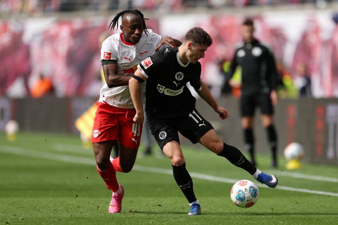LEIPZIG, GERMANY - MAY 09: Arkadiusz Pyrka of FC St. Pauli is challenged by Yan Diomande of RB Leipzig during the Bundesliga match between RB Leipzig and FC St. Pauli at Red Bull Arena on May 09, 2026 in Leipzig, Germany. (Photo by Maja Hitij/Getty Images)