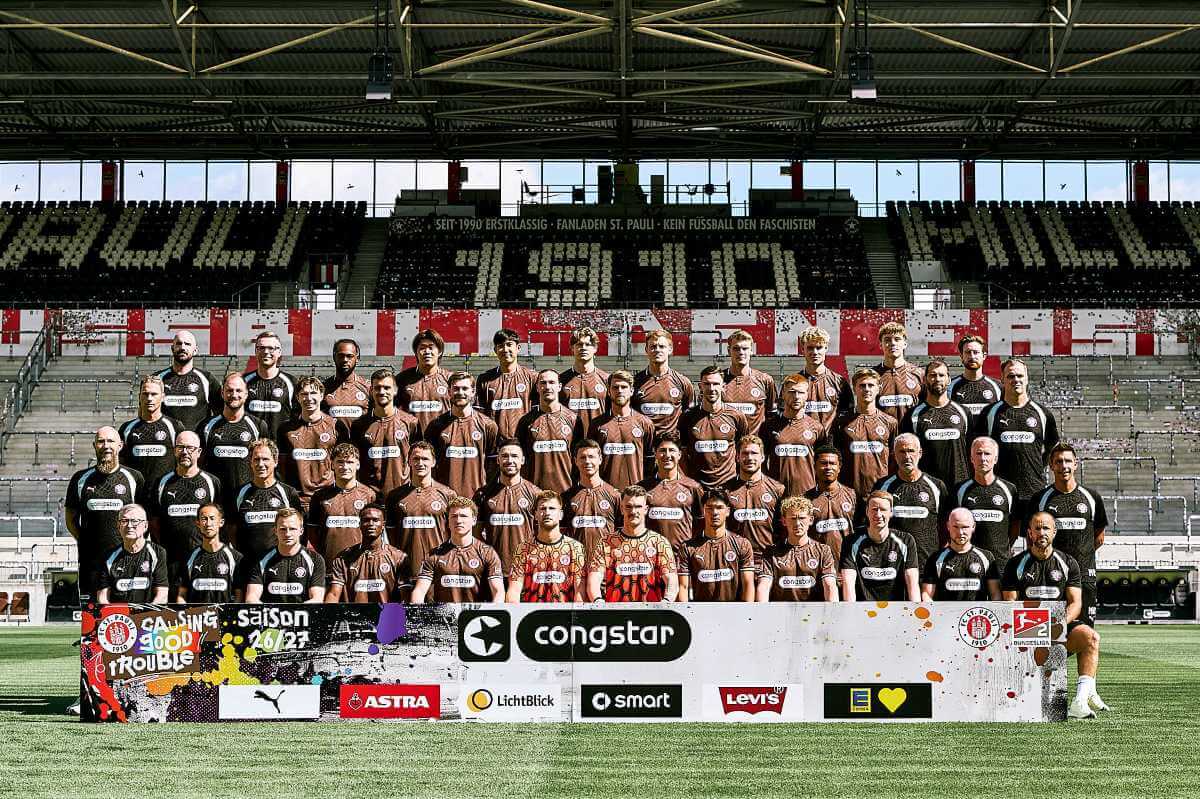Teamfoto des FC St. Pauli 2026/27:
Hinterste Reihe (v.l.n.r.): Frederic Bokelmann (Reha-Trainer), Dominik Körner (Physiotherapeut), Ricky-Jade Jones, Tomoya Andō, Taichi Hara, Jannik Robatsch, Eric Smith, David Nemeth, Sam Klein, Jannik Westphal, Jonas Wömmel (Teammanager)

Dritte Reihe (v.l.n.r.): James Morgan (Performance Management; Leiter Prävention, Physiotherapie & Rehabilitation), Jan Altmeyer (Physiotherapeut), Scott Banks, Adam Dźwigała, Connor Metcalfe, Jackson Irvine, Marcus Mathisen, Branimir Hrgota, Louis Oppie, Erik Ahlstrand, Thomas Barth (Athletiktrainer), Sven Van Der Jeugt (Torwarttrainer)

Zweite Reihe (v.l.n.r.): Thorge Blöcker (Zeugwart), Dr. Sebastian Schneider (Mannschaftsarzt), Dr. Volker Carrero (Mannschaftsarzt), Arkadiusz Pyrka, Martijn Kaars, Mathias Pereira Lage, Mathias Rasmussen, Haron Sabah, Lars Ritzka, Joel Chima Fujita, Peter Németh (Co-Trainer), Jens Schuster (Co-Trainer), Marcel Rapp (Cheftrainer)

Vorderste Reihe (v.l.n.r.): Siegmar Krahl (Zeugwart), Kenta Kambara (Zeugwart), Marius Abraham (Physiotherapeut), Abdoulie Ceesay, Rawley St. John, Ben Voll, Simon Spari, Nick Schmidt, Marwin Schmitz, Niklas Lanwehr (Spielanalyst), Sami Pierau (Spielanalyst), Karim Rashwan (Athletiktrainer)