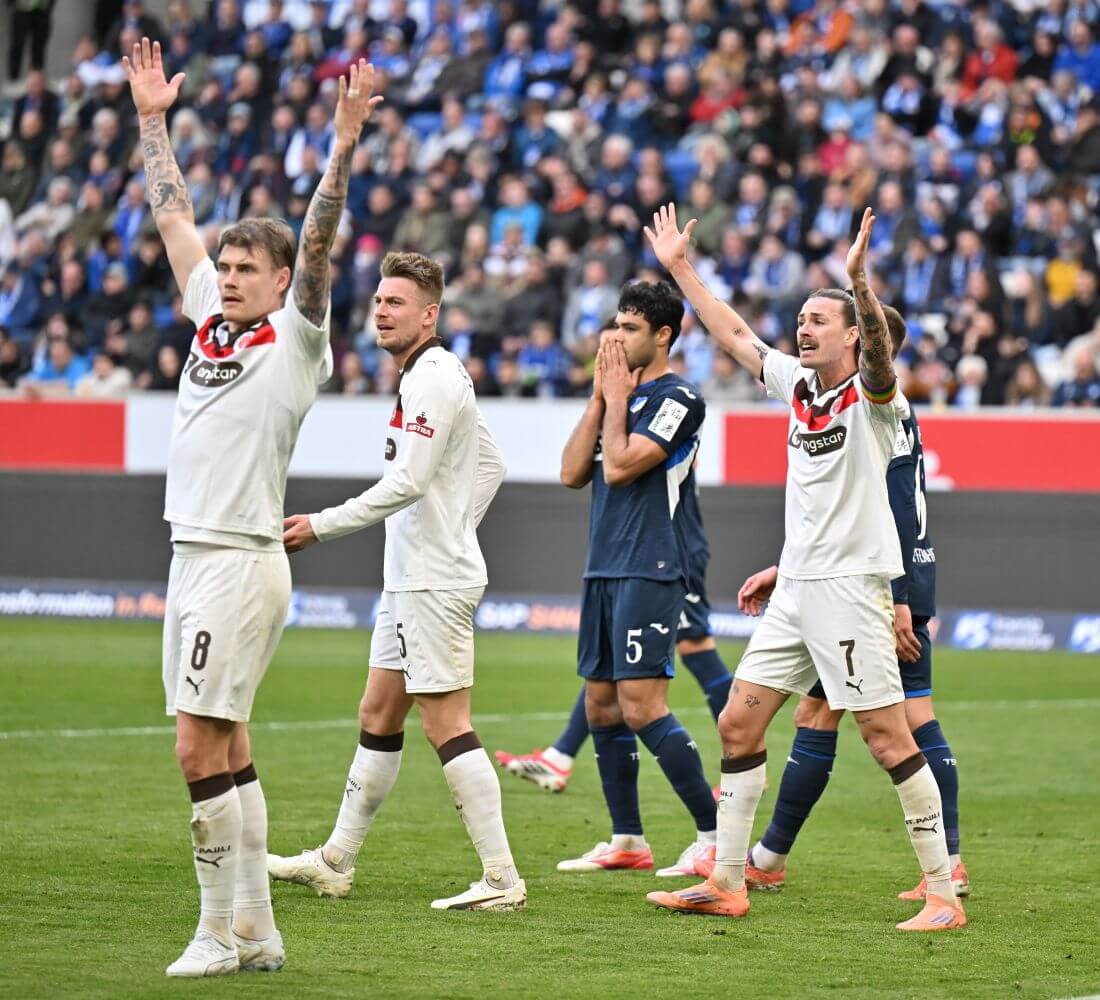 SINSHEIM, GERMANY - FEBRUARY 28: Eric Smith, Hauke Wahl and Jackson Irvine of FC St.Pauli gesture while Ozan Kabak of TSG Hoffenheim reacts during the Bundesliga match between TSG Hoffenheim and FC St. Pauli at PreZero-Arena on February 28, 2026 in Sinsheim, Germany. (Photo by Sebastian Widmann/Getty Images)