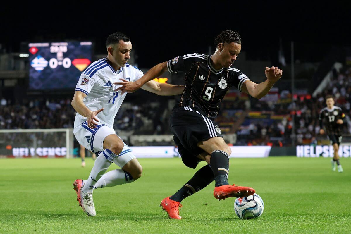 THESSALONIKI, GREECE - OCTOBER 04: Derry Scherhant of Germany is challenged by Manolis Saliakas of Greece during the UEFA Nations League 2026/27 group phase match between Greece and Germany at Toumba Stadium on October 04, 2026 in Thessaloniki, Greece. (Photo by Maja Hitij/Getty Images)